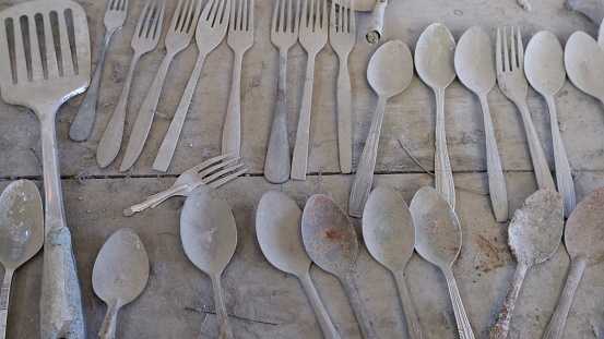 Kitchen utensils covered by ash in the aftermath of volcanic eruption in Java, Indonesia