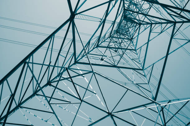 istock Abstract pattern from bottom view of high voltage pole power electricity transmission tower post. 1619958798