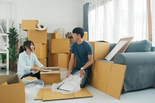 istock Young married couple moving into new home. 1619958805