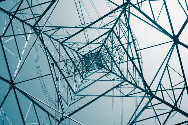 istock Abstract pattern from bottom view of high voltage pole power electricity transmission tower post. 1619959324