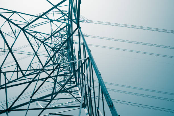 istock Abstract pattern from bottom view of high voltage pole power electricity transmission tower post. 1619959325