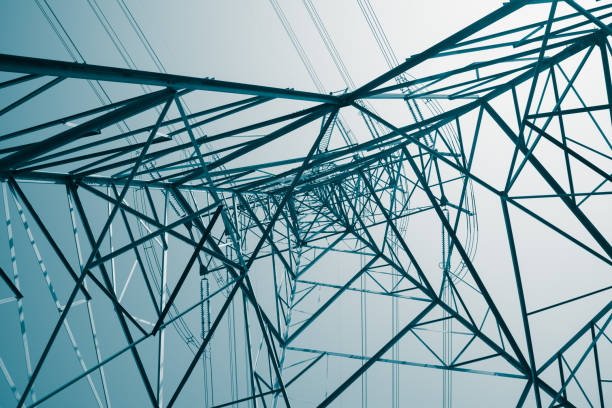 istock Abstract pattern from bottom view of high voltage pole power electricity transmission tower post. 1619960360