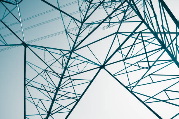 Abstract pattern from bottom view of high voltage pole power electricity transmission tower post.
