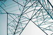 Abstract pattern from bottom view of high voltage pole power electricity transmission tower post.