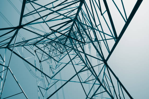 istock Abstract pattern from bottom view of high voltage pole power electricity transmission tower post. 1619961451