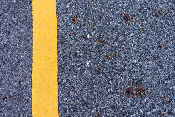 istock The paved road intersects with the yellow road line. 1619972383