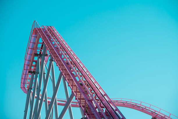istock Pink pastel looping rollercoaster in amusement park with clear blue sky background sunny day. 1619972587