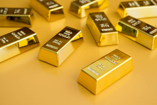 istock Gold bars or bullion on yellow background. 1620040014