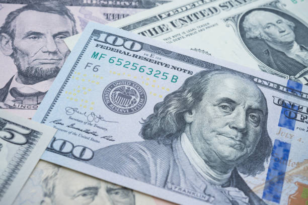 istock US president on many US dollars bill banknote background. 1620042097