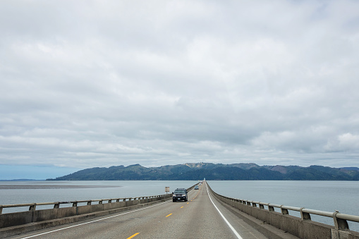 The Astoria–Megler Bridge crosses the Columbia river, connecting the states of Oregon and Washington; viewed on an overcast day entering into Washington.