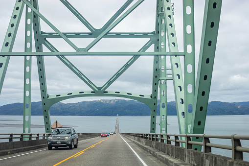 Astoria, USA - August 8, 2023. Vehicle traffic crosses from Oregon to Washington via the Astoria-Megler Bridge.