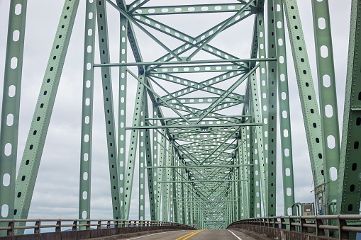 The Astoria–Megler Bridge crosses the Columbia river, connecting the states of Oregon and Washington; viewed on an overcast day entering into Washington.