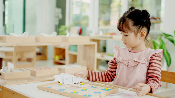 istock Preschool mixed girl learning about shape using geometric inset, 1620062569