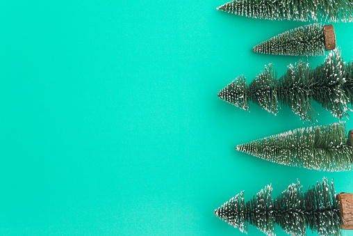 Top view Christmas pine tree on green background copy space minimal style. Christmas composition for your design in holiday winter festival (xmas, christmas eve and new year) concept.