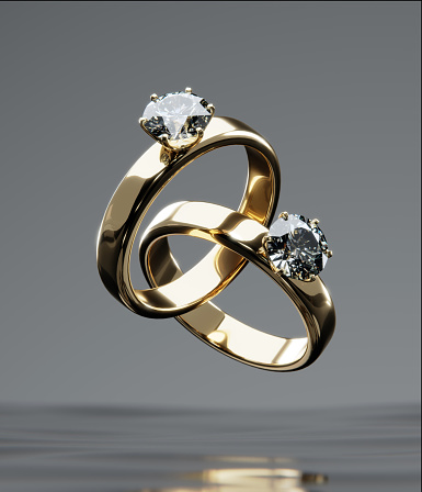 Two gold diamond rings floats on the surface of the water scene. from design with 3D render.