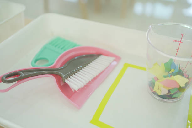 A Montessori classroom set-up, brush and dustpan, practical life materials, homeschooling education