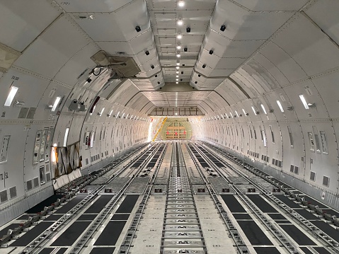 An interior of an empty cargo hold of an airplane