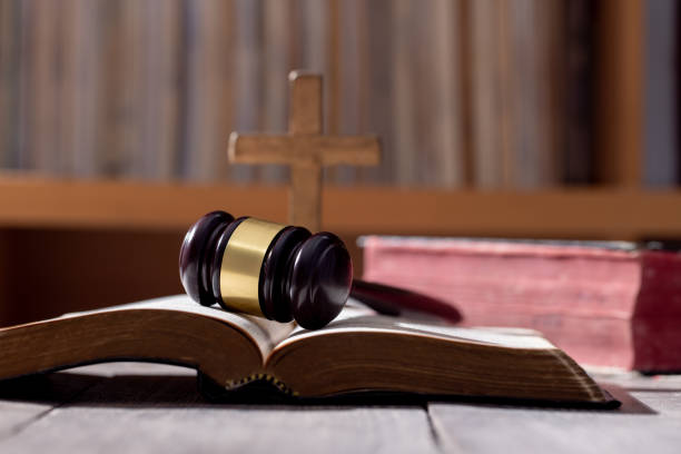 Holy bible book and judge's gavel on table background. Judicial system, constitution, democracy, rule of law. There are no people in the photo. There is free space to insert. stock photo