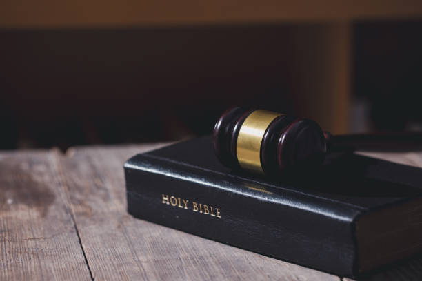 istock Holy bible book and judge's gavel on table background. Judicial system, constitution, democracy, rule of law. There are no people in the photo. There is free space to insert. 1620079494