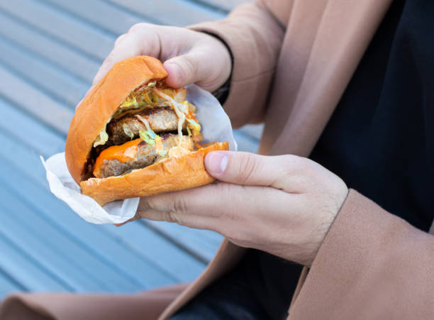 istock burger with 2 cutlets holding a man 1620079819