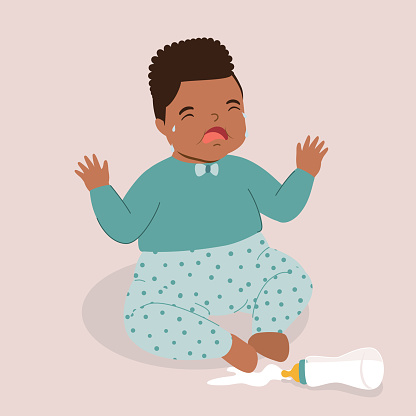 One Little Black Baby Boy Crying Over The Spilled Milk On The Floor. Isolated On Color Background.