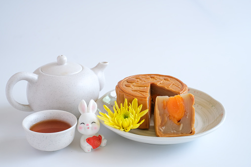 Chinese Mid-Autumn Festival concept made from mooncakes, tea isolated on white background.