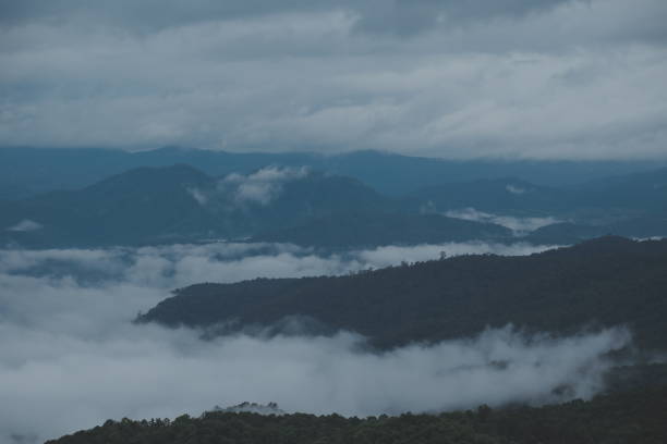 istock Mountain range with visible silhouettes through the morning blue fog. 1620200863