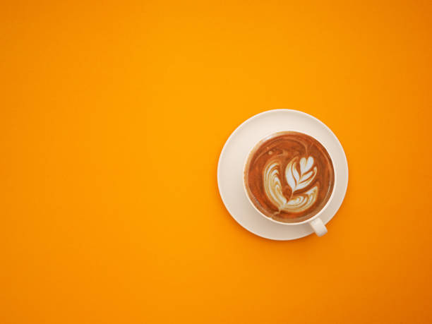 istock Top view of a fresh coffee cup over an orange background 1620220291