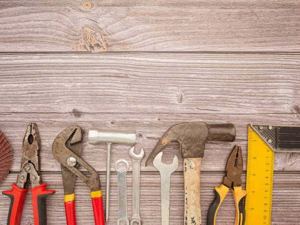 istock Construction tools, a hammer, screwdriver, screws, and pliers on a wooden table 1620224002