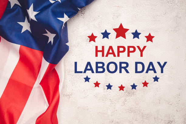 istock Happy Labor Day text over a cement floor and American Flag 1620224519