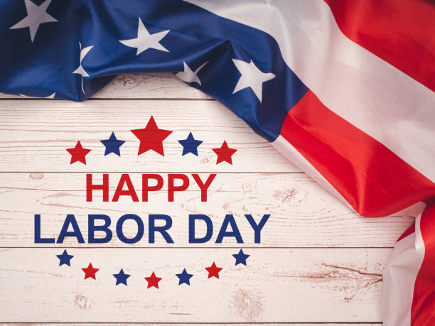 istock Happy labor day text over a wooden table and American Flag 1620233763