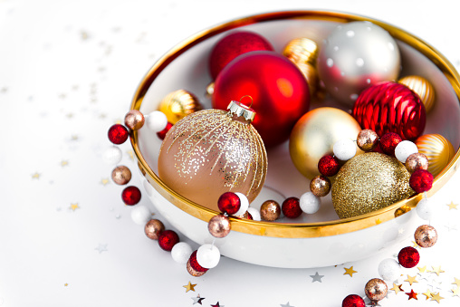 holidays concept - shiny christmas balls on white background