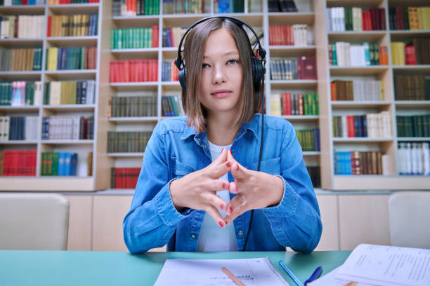 istock Close-up webcam view of face female student, inside university library 1620255998