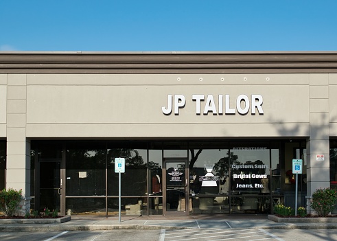 Houston, Texas USA 07-30-2023: JP Tailor business storefront in Houston, TX. Local Tailoring and alterations store, front view.