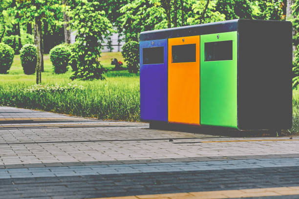 istock Ecology. Waste containers for plastic, paper and glass in a summer park 1620267480