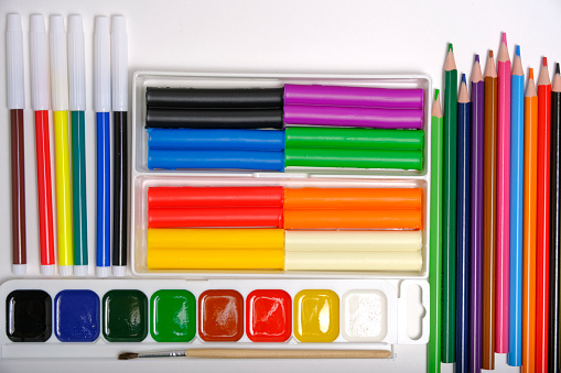 colored pencils are scattered on a light background. High quality photo