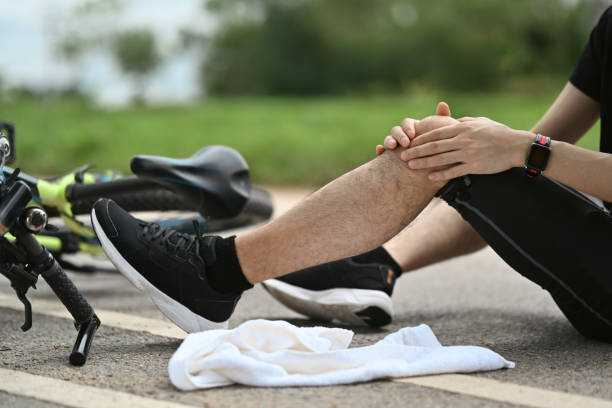 istock Man cyclist with injured knee sitting near bicycle outdoors, falling down from bicycle. Concept accident from bicycle 1620281205