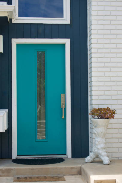 istock Bright turquoise front door to a mid century modern beach bungalow 1620298083