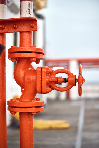 Ships  Fire manifold isolating valve  orange color located on main deck.