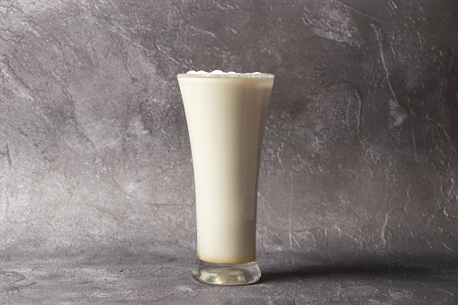 Vanilla Milkshake or lassi and milk served in glass isolated on background top view of bangladesh food