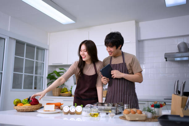 istock Young couple is livestreaming in kitchen. 1620317887