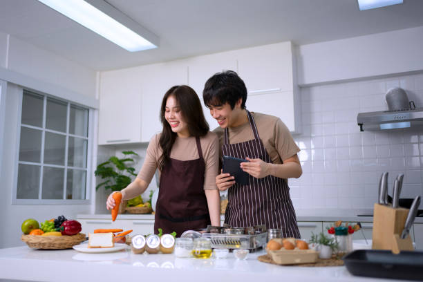 istock Young couple is livestreaming in kitchen. 1620318412