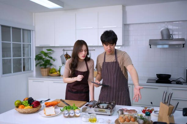 istock Young couple is livestreaming in kitchen. 1620318413