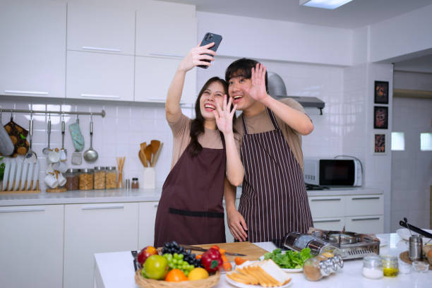istock Young couple is livestreaming in kitchen. 1620318943