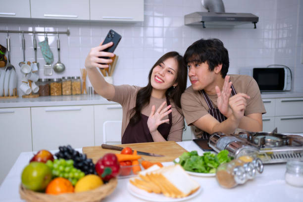 istock Young couple is livestreaming in kitchen. 1620318968