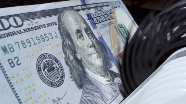 istock electronic money counter machine is counting is counting the American hundred-dollar (US dollars) banknotes 1620321687