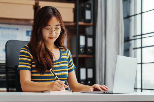 istock Excited Asian female student doing Online MBA and Business Degree Programs and learn indian language, online MBA course give you same level education provided conventional business school 1620327068