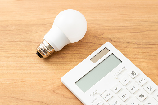 LED bulb and calculator on the table.