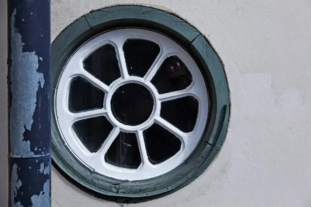 an old round window with white spokes