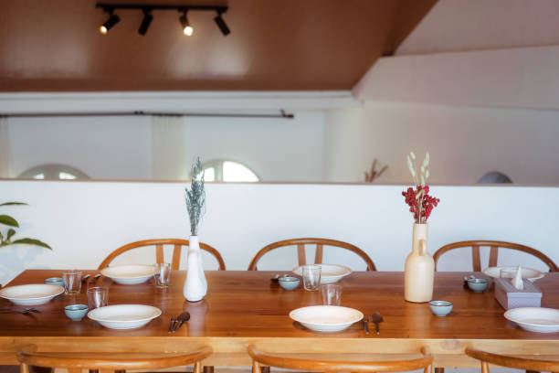 istock Wooden Dining Table With Plant Glass and Table Decor 1620349597